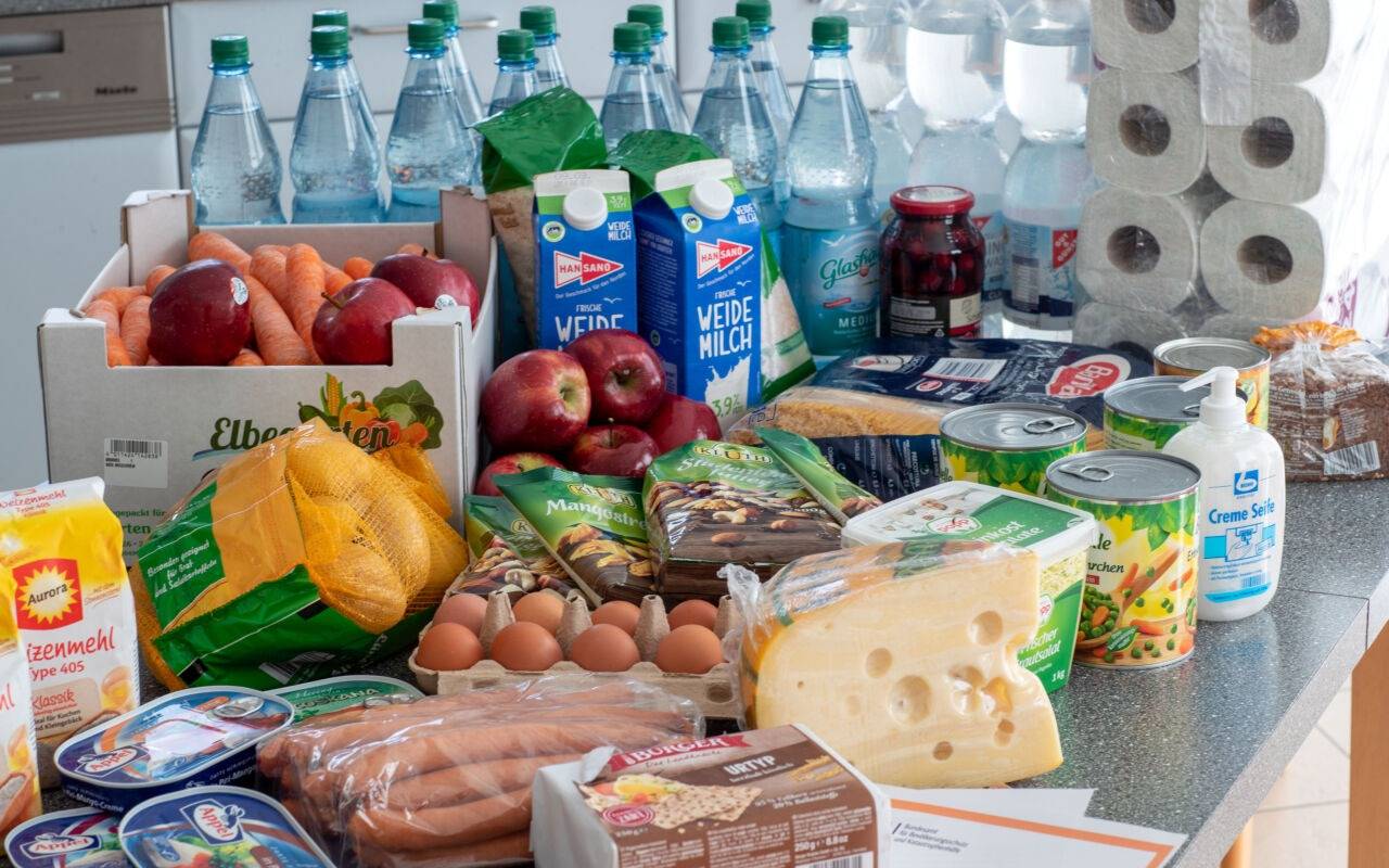 Lebensmittel und Produkte des täglichen Bedarf liegen auf einem Küchentisch in einem Privathaus.